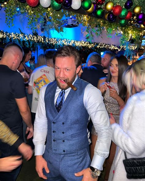 Conor McGregor Enjoys Cigar in Festive Attire at…