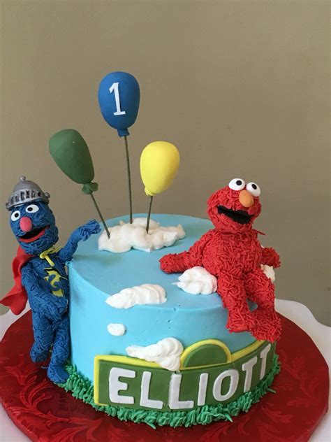 Sesame Street birthday cake with Elmo and super Grover. White cake with milk chocolate m ...