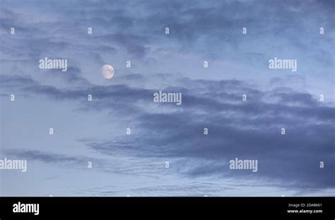 Evening sky with clouds and moon Stock Photo - Alamy