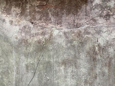 Premium Photo | A cracked concrete wall with a crack in the middle.