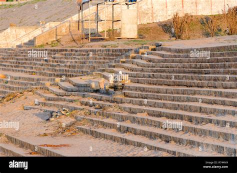 Ruined Shiva linga and Nandi bull statue on a staircase at Tungabhadra River Ghat, Hampi ...