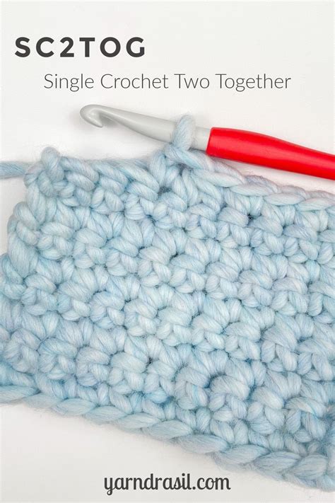 the crochet stitch is being worked on by a red handled knitting needle ...