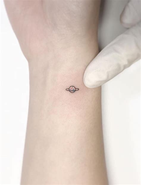 Planet Tattoo - Tattoo Insider | Simplistic tattoos, Planet tattoos, Tiny tattoos for girls