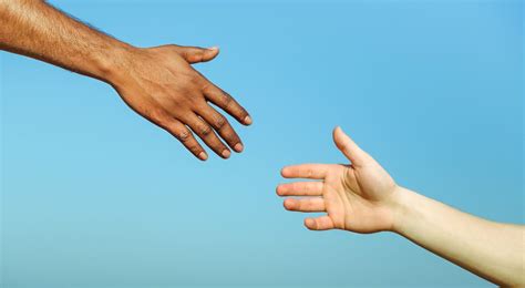 Black hand man helping white person - Different skin color hands ...