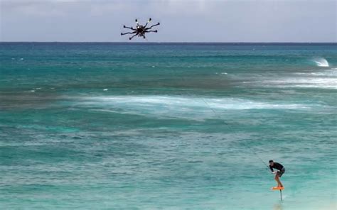 Drone tow-in surfing with a foil board