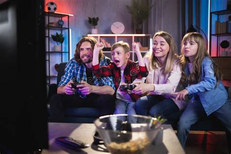 Young Parents with Kids Playing Video Games at Hom Stock Image - Image ...