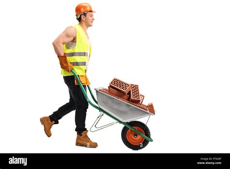 Construction worker pushing a wheelbarrow full of bricks isolated on Stock Photo, Royalty Free ...