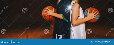 Kids Basketball Team. Young Basketball Players Holding Balls On ...