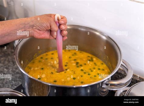 hand of a grandmother mixing the ingredients of the fanesca that is ...