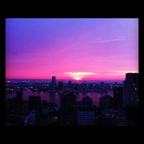the sun is setting over new york city