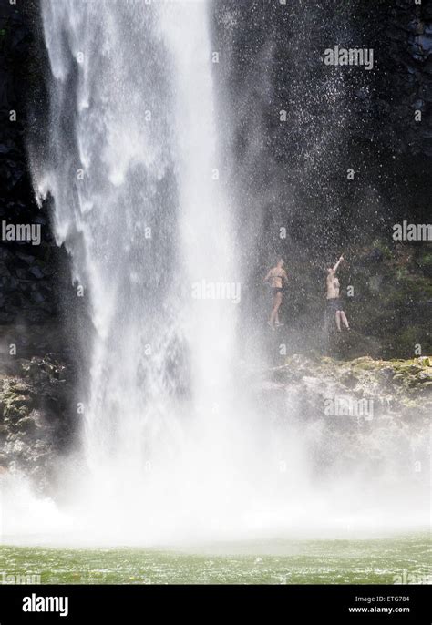 Couple hiking behind Wailua Falls, Kauai, Hawaii Stock Photo - Alamy