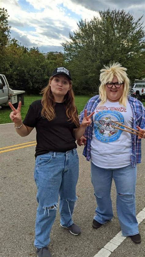 two women standing next to each other in a parking lot