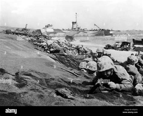 IWO JIMA--Marines of the Fourth Division pinned down by enemy fire as they hit the beach at Iwo ...