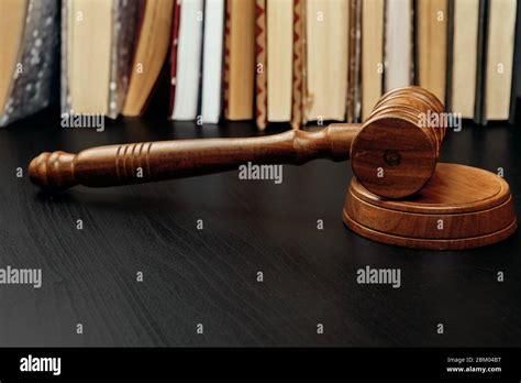 Judge's gavel on wooden table in dark Stock Photo - Alamy