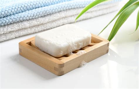 White Bar of Soap in Wooden Dish on a Green Background. Directly Above ...