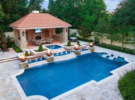 a backyard with a swimming pool and outdoor entertainment area