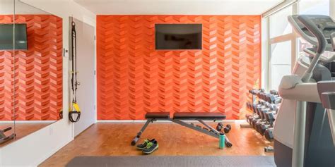 Home Gym With Patterned Orange Wall | Home gym design, Gym design, Home ...