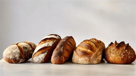 Premium AI Image | Variety of artisan bread loaves on a neutral backdrop