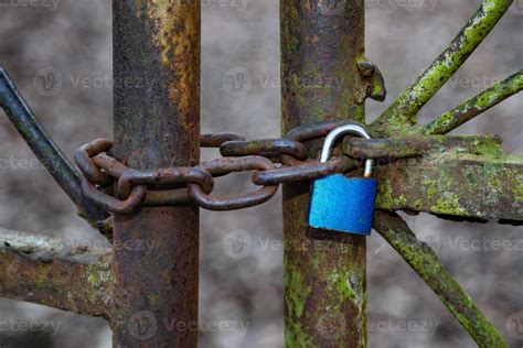 Old rusty and aged gate. Weathered door locked with padlock. 4693894 Stock Photo at Vecteezy