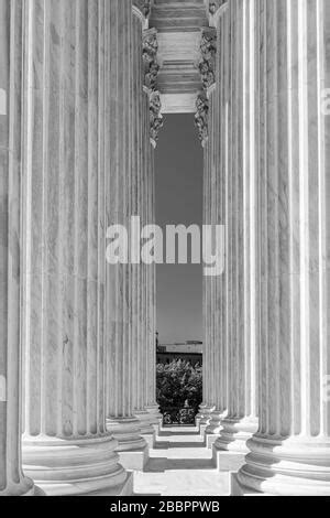 White marble neoclassical columns of the portico of the Supreme Court of the United States ...