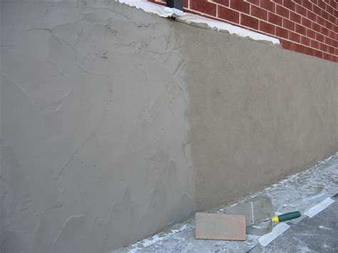 Parging - Applying a mortar coat with a trowel to control leakage in masonry walls, usually ...