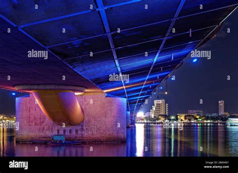 Colorful illumination under the bridge at night. Low angle view of Dragon bridge construction ...