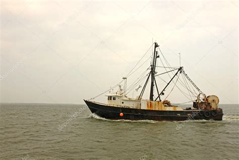 Old, rusty fishing trawler in early morning mist — Stock Photo © sgoodwin4813 #6979478