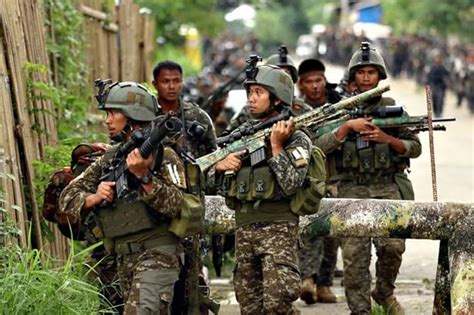 Operators from the Philippine Army Light Reaction Regiment marching into the Main Battle Area ...