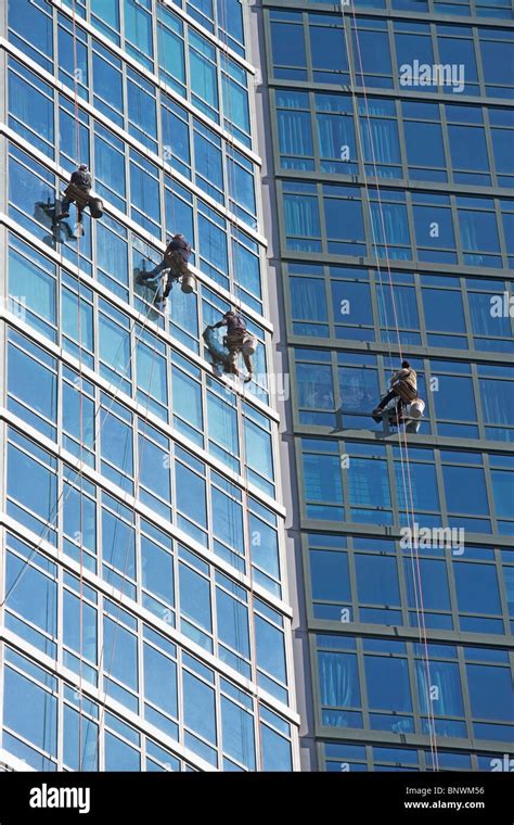 Window washers cleaning windows on skyscraper Stock Photo - Alamy