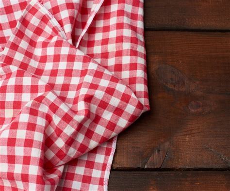 Premium Photo | Red-white textile kitchen towel on a brown wooden