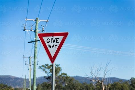 Image of Give Way sign on post with copy space - Austockphoto