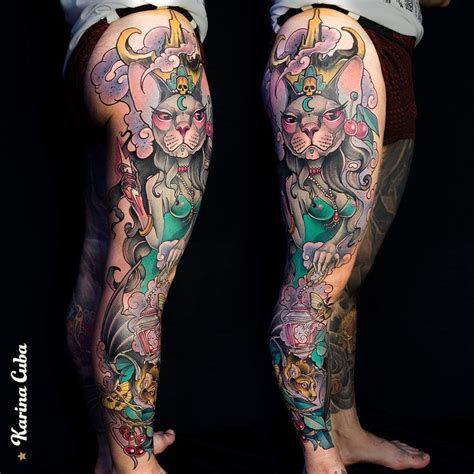 a person with tattoos on their legs and leggings that have cats in them