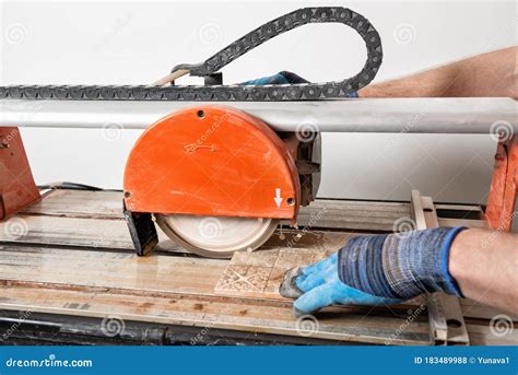 Wet cutting a ceramic tile stock photo. Image of craftsman - 183489988