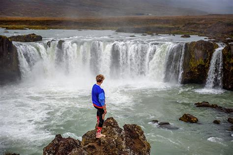 Hiker standing at the Godafoss waterfall in Iceland Photograph by Miroslav Liska - Pixels