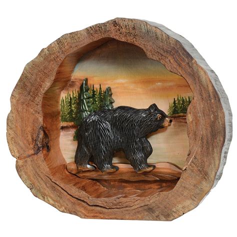 a bear on a log with trees and water in the background, painted on wood