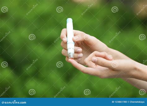 Woman using lancet pen stock photo. Image of finger - 123861780