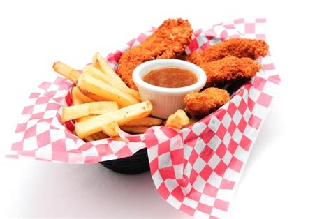 Premium Photo | Breaded chicken strips with french fries and dipping ...