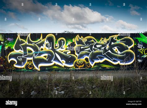 A concrete wall covered in Graffiti Stock Photo - Alamy