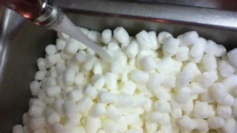 Dissolving biodegradable packing peanuts in a sink - YouTube