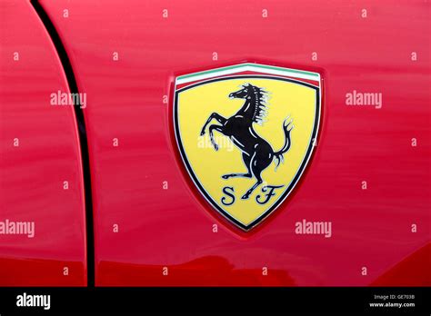 a close up of a Ferrari badge on a red Ferrari car Stock Photo - Alamy