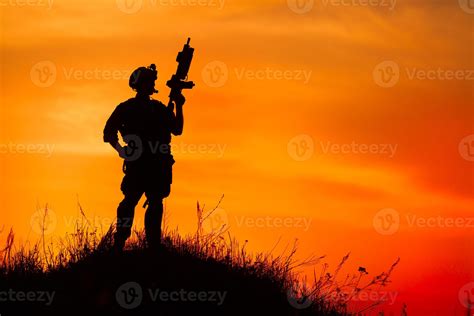 Silhouette of military soldier or officer with weapons at sunset ...