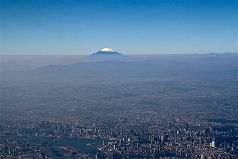 Aerial shot of Tokyo with Mount Fuji in the distance - Photorator