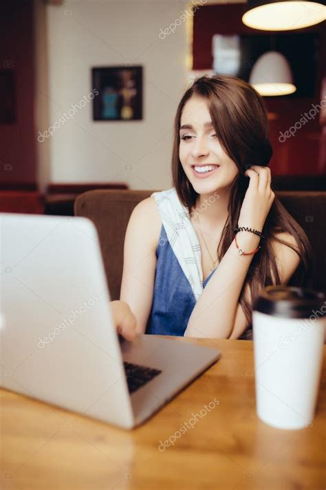 Woman working on laptop in coffee shop Stock Photo by ©dan.grytsku.gmail.com 115610198