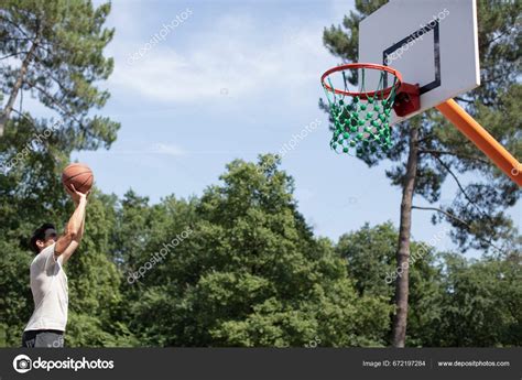 Basketball Player Taking Jump Shot Basketball Court Stock Photo by ...