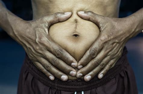 Premium Photo | Midsection of man making heart shape on belly
