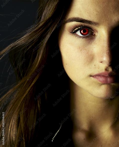 Portrait of beautiful vampire young woman with red eyes. Stock Photo ...