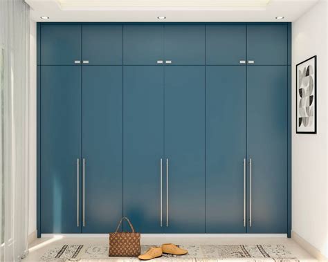 Modern Matt Blue Finished Wardrobe Design with Metallic Handles | Livspace