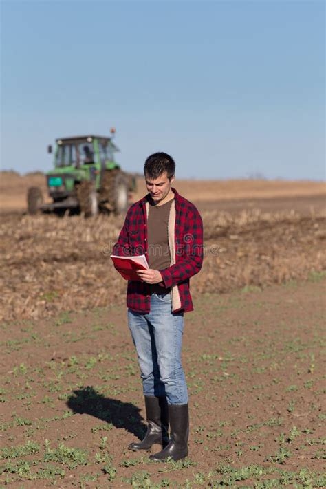 Farmer with Tractor on Field Stock Photo - Image of peasant, land: 62961952