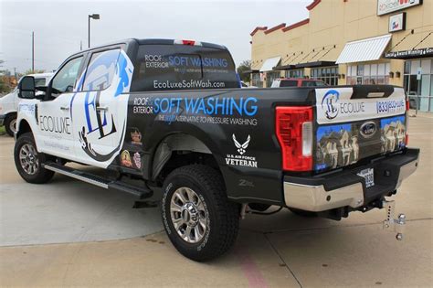 a truck parked in front of a building with the words soft washing ...