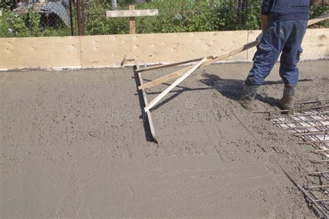 Worker Leveling Fresh Concrete Slab with a Special Working Tool Stock ...